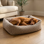 Beige corduroy orthopaedic pet bed with cushioned bolsters and textured fabric; dog lying down