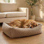 Beige corduroy orthopaedic pet bed with cushioned bolsters and textured fabric; golden dog resting