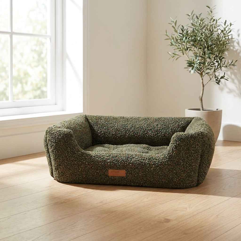 Orthopaedic dog bed with dark green textured fabric, raised bolsters and tan logo patch