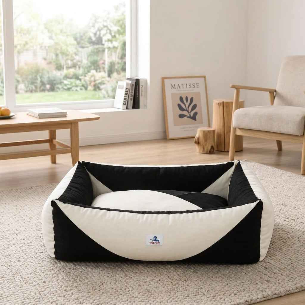 Orthopaedic dog bed with black sides and white pressure-relief bolster in a low oval shape