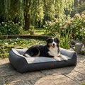 Gray upholstered sofa bed with cushioned armrests and wide lounge base
