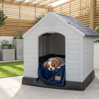 Raised plastic dog kennel with ramp, white arched door; dog curled on blue blanket.