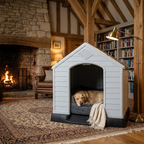 Raised plastic dog kennel with ramp, white arched door; dog on dark cushion.