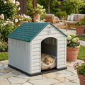 Navy and white plastic dog house with arched entrance and textured roof; dog sleeping inside